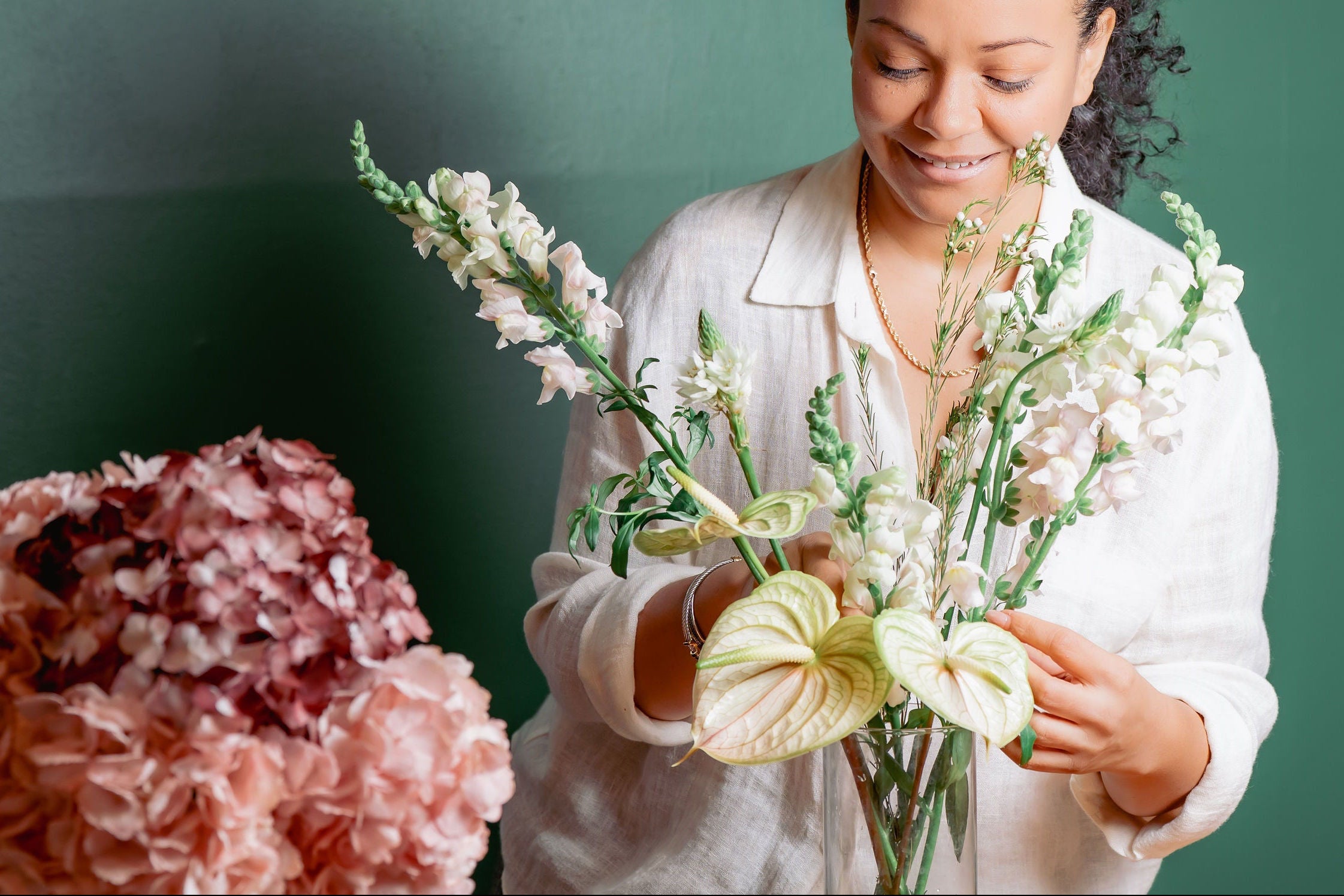 Woman arranging Bridal flowers with growing with 'TIFF' branding in the background
